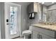 Bathroom featuring a granite countertop, decorative tiled window, and modern fixtures at 1945 Via Lago Dr, Lakeland, FL 33810
