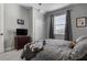 This bedroom has carpet, a dresser, TV, a ceiling fan and curtains over the window at 1945 Via Lago Dr, Lakeland, FL 33810