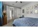Well-lit bedroom featuring a comfortable bed, doorway access to the ensuite bathroom at 1945 Via Lago Dr, Lakeland, FL 33810