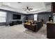 Relaxing bonus room with sectional sofa, large screen television, and neutral carpeting at 1945 Via Lago Dr, Lakeland, FL 33810