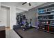 Workout area with exercise bike, mirror wall, shelves, and rubber flooring at 1945 Via Lago Dr, Lakeland, FL 33810