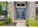 Close up of front entrance with custom glass paneled double door entry at 1945 Via Lago Dr, Lakeland, FL 33810