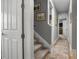Hallway with carpeted stairs, neutral decor, and inviting view into the bedrooms at 1945 Via Lago Dr, Lakeland, FL 33810