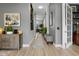 Bright hallway featuring wood floors and neutral decor leading to a living space with natural light at 1945 Via Lago Dr, Lakeland, FL 33810