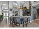 Elegant kitchen with a breakfast bar, gray cabinets, and stainless-steel appliances with seamless access to the foyer at 1945 Via Lago Dr, Lakeland, FL 33810