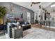 Spacious living room with a large gray sectional sofa, hardwood floors, and an open layout at 1945 Via Lago Dr, Lakeland, FL 33810