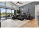 Open-concept living room with vaulted ceilings, large windows, and modern furnishings with access to the lanai at 1945 Via Lago Dr, Lakeland, FL 33810