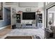Cozy living room featuring built-in shelving, a large flat-screen television, and neutral decor at 1945 Via Lago Dr, Lakeland, FL 33810