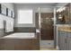 Modern main bathroom showcasing a soaking tub, tiled shower, and gray vanity at 1945 Via Lago Dr, Lakeland, FL 33810