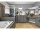 Main bathroom features a soaking tub, tiled shower, granite countertops, and dual sinks at 1945 Via Lago Dr, Lakeland, FL 33810