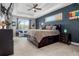 Relaxing main bedroom features a tray ceiling, accent wall, and a cozy seating area at 1945 Via Lago Dr, Lakeland, FL 33810