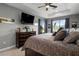 Cozy main bedroom with a tray ceiling, plush carpet, and ample natural light at 1945 Via Lago Dr, Lakeland, FL 33810