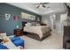 Spacious main bedroom featuring a dark accent wall, plush carpet, and an exterior view at 1945 Via Lago Dr, Lakeland, FL 33810