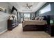 Stylish main bedroom featuring a tray ceiling, neutral colors, and an exterior view at 1945 Via Lago Dr, Lakeland, FL 33810