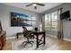Bright home office with a large window, dark wood desk, and beach themed art at 1945 Via Lago Dr, Lakeland, FL 33810