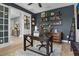 Stylish home office with dark wood furniture, shelves, and a view into another room at 1945 Via Lago Dr, Lakeland, FL 33810