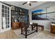 Well-decorated home office featuring dark wood furniture, open shelving, and beach-themed art at 1945 Via Lago Dr, Lakeland, FL 33810