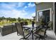 Outdoor patio seating area with table, chairs, and serene green landscape view at 1945 Via Lago Dr, Lakeland, FL 33810