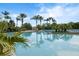 Community pool offers calm waters and scenic views of the palms and lounge area for residents to enjoy at 1945 Via Lago Dr, Lakeland, FL 33810