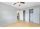 Bright bedroom features a ceiling fan, closet, and adjacent bathroom at 226 S Apollo Dr, Apopka, FL 32703