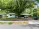 View of the front of a home with a large tree in the yard and a chain-link fence at 226 S Apollo Dr, Apopka, FL 32703