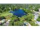 Beautiful aerial view of a lake surrounded by lush greenery and houses at 228 Deleon Rd, Debary, FL 32713