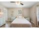 Cozy bedroom with neutral tones, ceiling fan, and wood-look flooring at 228 Deleon Rd, Debary, FL 32713