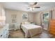 Comfortable bedroom with ceiling fan, wood-look flooring, and bright windows at 228 Deleon Rd, Debary, FL 32713