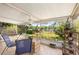 Relaxing covered patio area overlooking a scenic yard, hammock, and lake for outdoor enjoyment at 228 Deleon Rd, Debary, FL 32713