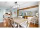 Open dining room with wood floors and beam, flowing into kitchen and living area at 228 Deleon Rd, Debary, FL 32713