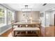 Dining room with a modern chandelier, large windows, and light wood table at 228 Deleon Rd, Debary, FL 32713