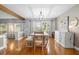Bright dining room with hardwood floors, updated lighting, and large windows at 228 Deleon Rd, Debary, FL 32713