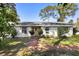 Inviting single-story home with manicured landscaping, creating a welcoming entrance at 228 Deleon Rd, Debary, FL 32713
