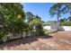 Charming home exterior with a white picket fence, flowering archway, and lush landscaping at 228 Deleon Rd, Debary, FL 32713