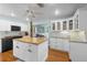 Spacious kitchen with white cabinets, granite countertops, and a butcher block island at 228 Deleon Rd, Debary, FL 32713