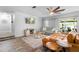 Cozy living area featuring wood-look tile, stylish furniture, and a screened in porch at 228 Deleon Rd, Debary, FL 32713