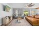 Bright living room with plush seating, a ceiling fan, and a large rug at 228 Deleon Rd, Debary, FL 32713