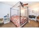 Comfortable bedroom featuring a four-post bed, ceiling fan and a floral pattern bedspread at 2411 Trafalgar Dr, Orlando, FL 32837