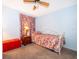 This bedroom has a floral bedspread and a red storage trunk that adds a pop of color at 2411 Trafalgar Dr, Orlando, FL 32837