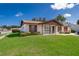 Charming single-story home with brick accents, shutters, and a well-maintained lawn at 2411 Trafalgar Dr, Orlando, FL 32837