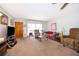 Cozy living room with neutral carpeting, plenty of seating, and natural light from the window at 2411 Trafalgar Dr, Orlando, FL 32837