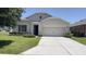 Charming one-story home featuring a well-manicured lawn and a two-car garage at 271 Tanglewood Dr, Davenport, FL 33896