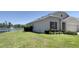 Back of the house shows a scenic lakeside view with a fountain at 271 Tanglewood Dr, Davenport, FL 33896
