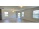 Living room with tile floors, multiple windows, and sliding glass door leading to the outdoors at 271 Tanglewood Dr, Davenport, FL 33896