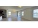 Bright living room with tile floors, ample windows, and sliding glass doors at 271 Tanglewood Dr, Davenport, FL 33896