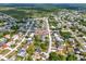 A high-angle view shows a home in a neighborhood outlined in red, with mature trees and well-kept lawns at 2764 W Covington Dr, Deltona, FL 32738