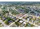 Aerial view of a home in a residential neighborhood, outlined in red, showcasing neatly arranged homes with landscaping at 2764 W Covington Dr, Deltona, FL 32738