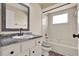 Bathroom featuring a vanity with dark accents, a soaking tub, and a window at 2764 W Covington Dr, Deltona, FL 32738