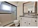 Bathroom featuring a tiled shower with glass doors and a vanity with dark accents at 2764 W Covington Dr, Deltona, FL 32738
