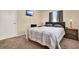 Bedroom with a mounted TV, plush carpet, neutral walls, and a dark headboard at 2764 W Covington Dr, Deltona, FL 32738